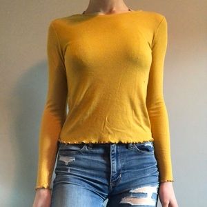 Yellow long sleeve shirt with ruffle hem